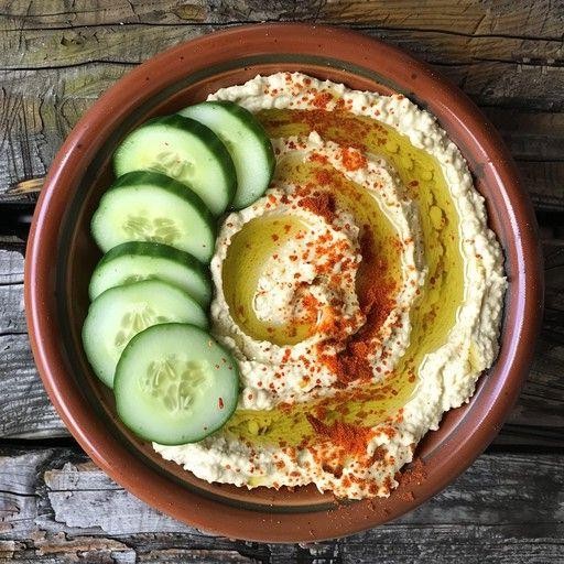Olive oil drizzled hummus with cucumber slices