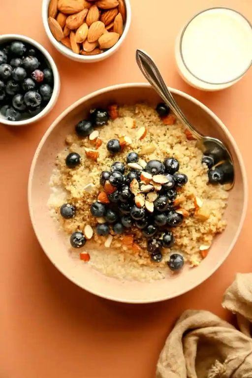 Quinoa breakfast bowl with almonds and dried apricots