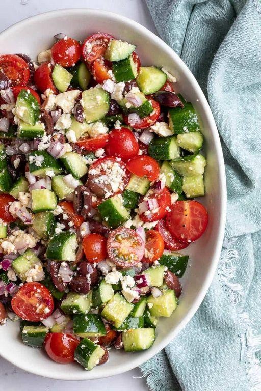 Tomato and cucumber salad with olives and olive oil