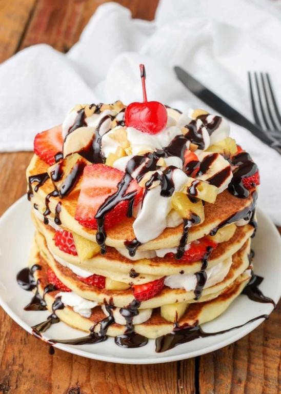 Banana Pancakes with Whipped Cream and Chocolate Sauce